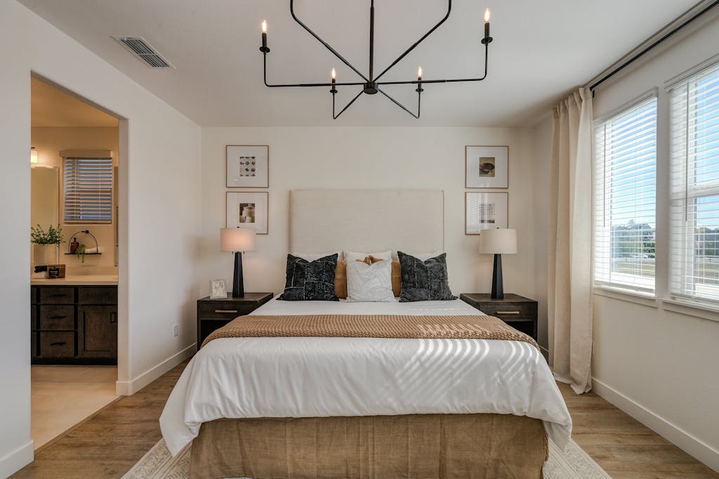 A stylish bedroom with contemporary decor and natural lighting.